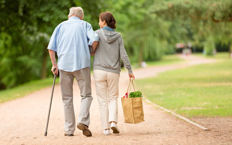 Caregiver – woman helping senior man with shopping